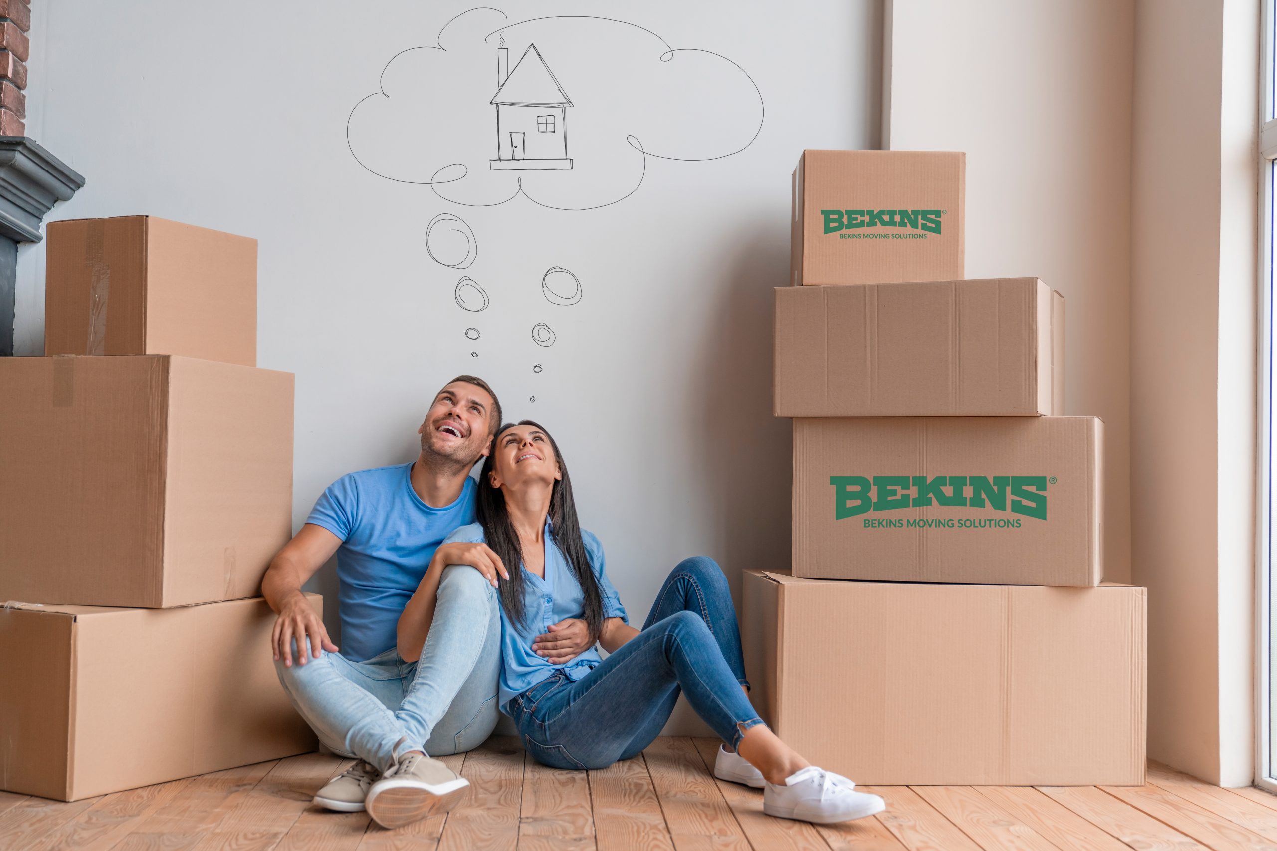 Young couple with dreaming about moving into new house