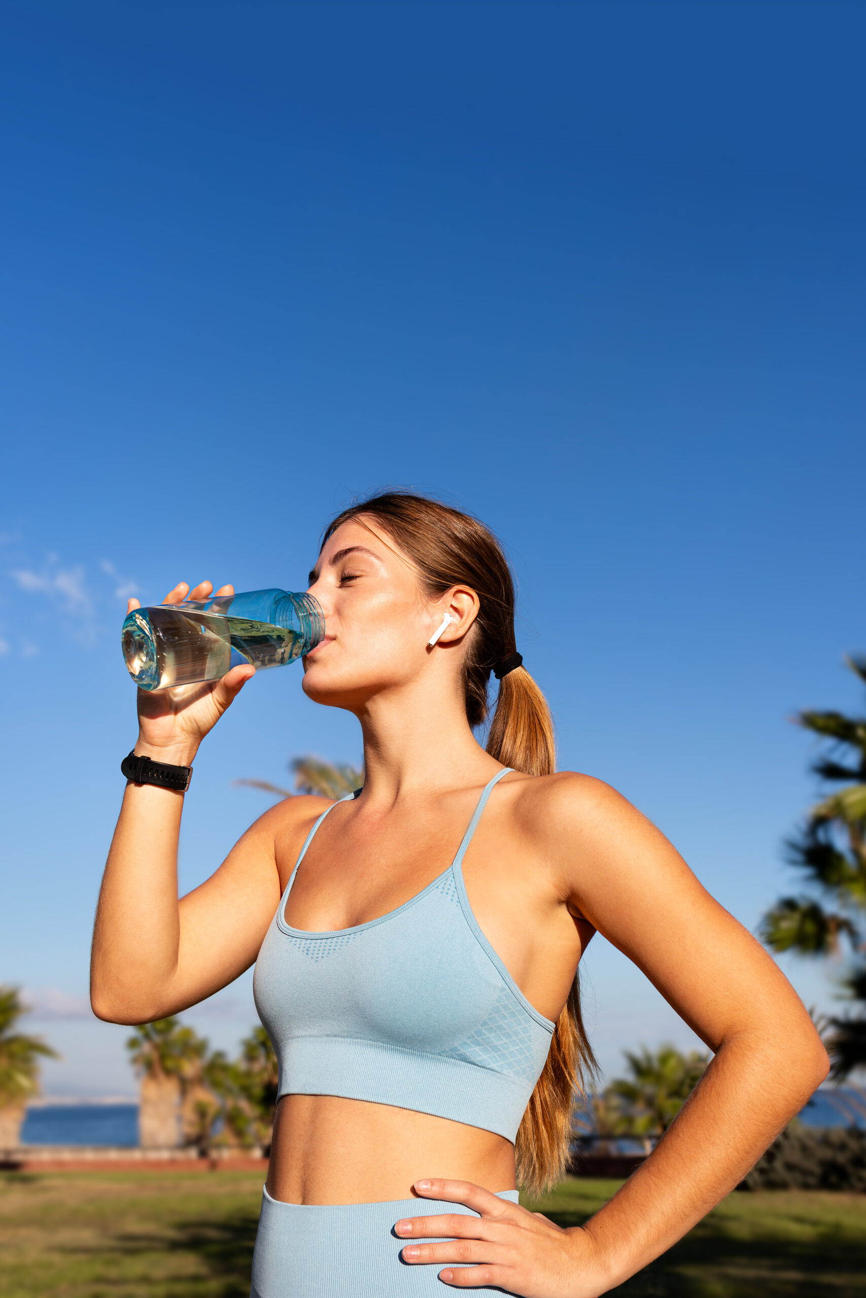 A woman drinking water.