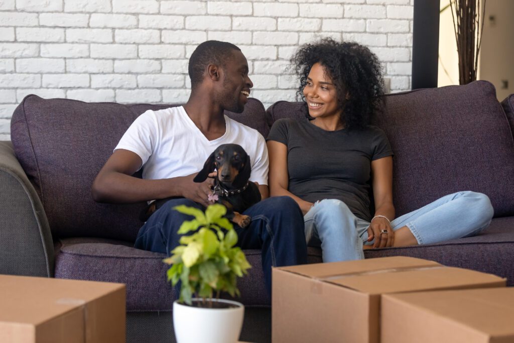 A couple and their dog moving.