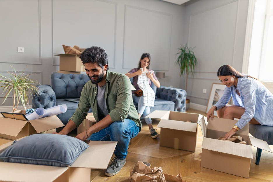 Roommates unpacking their boxes in a home.