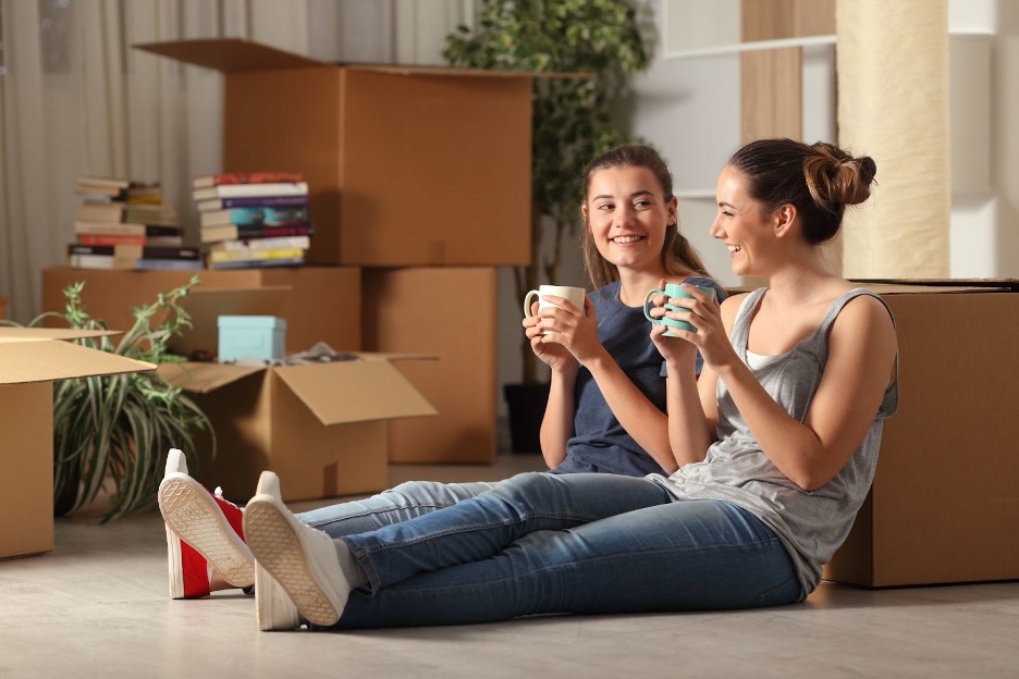 Roommates unpacking and drinking coffee.