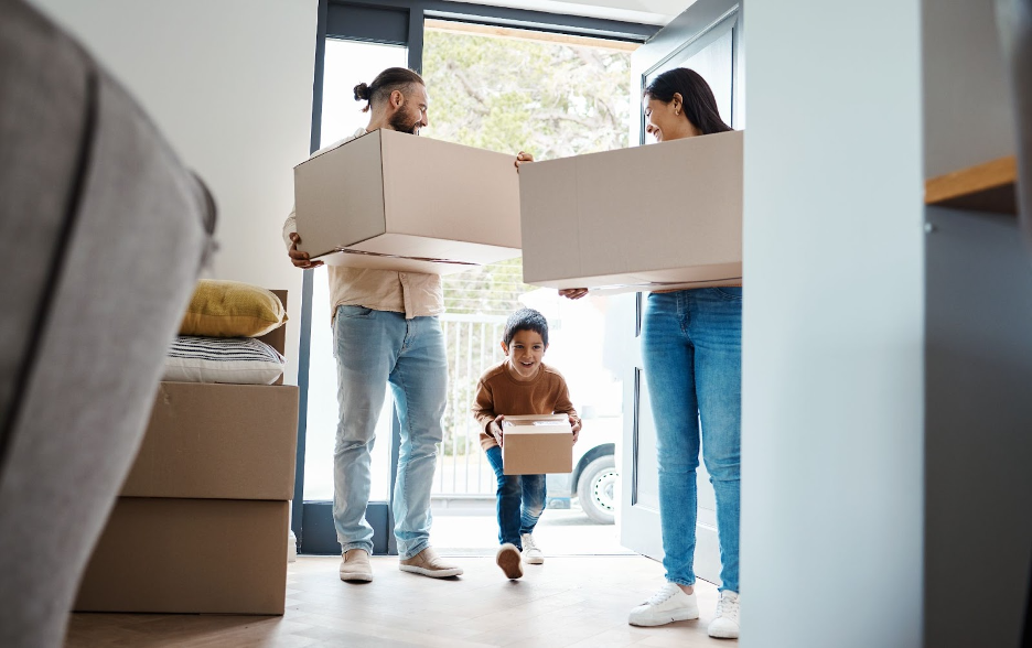 A family standing in front of their new home.