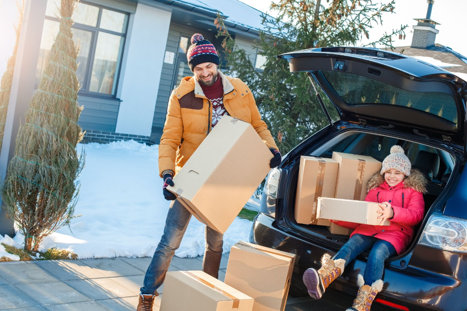A parent and child moving in winter.